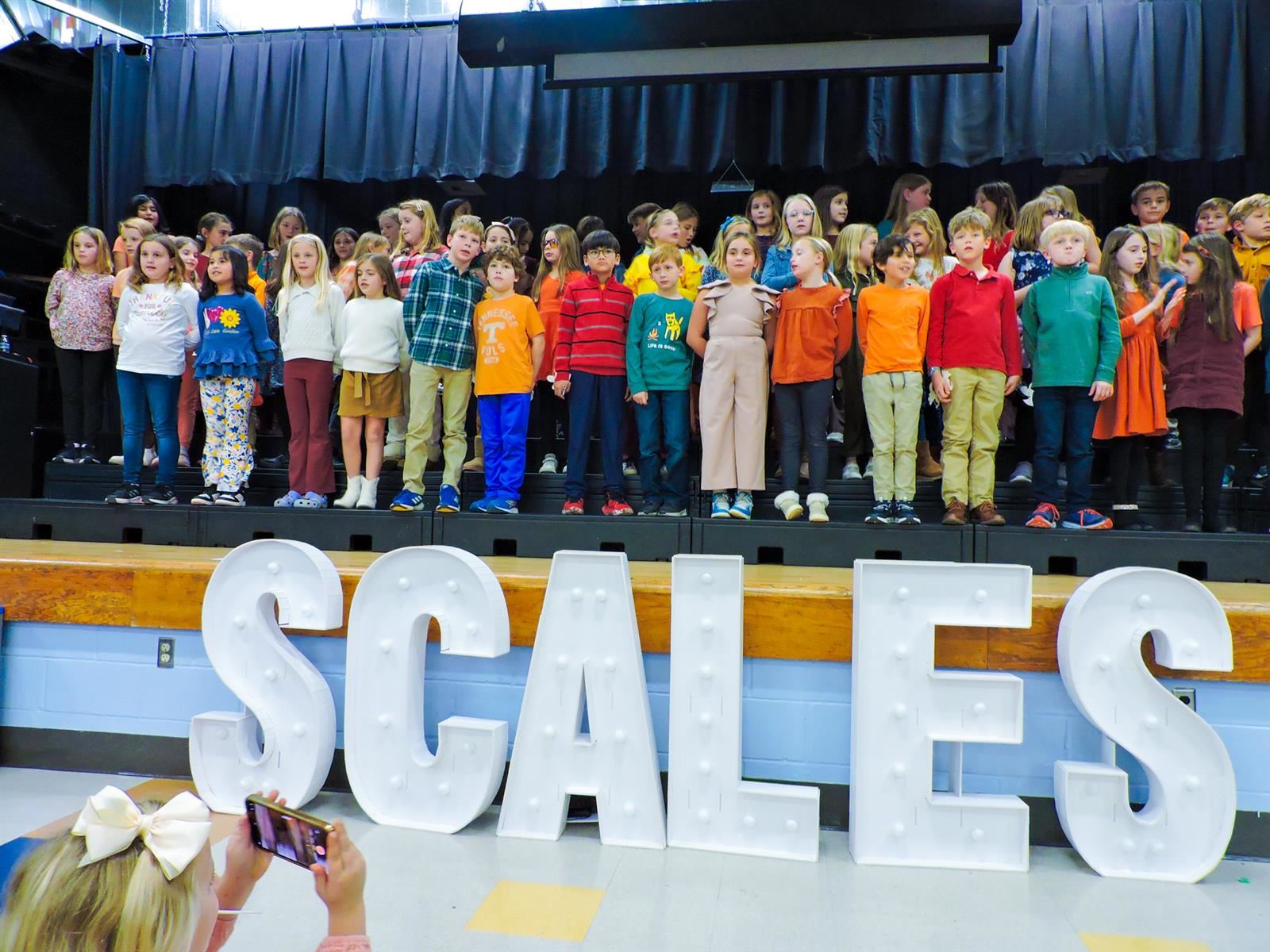 large group of students on stage